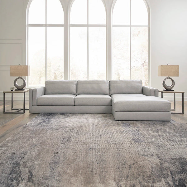 Amiata sectional sofa with chaise in genuine leather and faux leather blend ��� Ashley UAE
