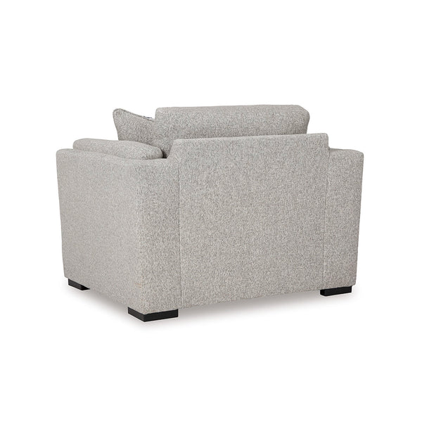 Side view of oversized chair with accent pillow and low-profile faux wood legs