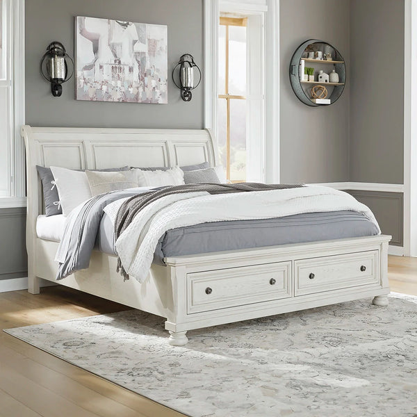 Robbinsdale queen sleigh bed in antiqued white finish with storage drawers – Ashley UAE