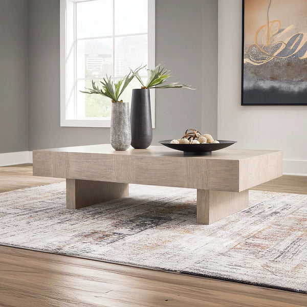 Jorlaina coffee table with textural light gray finish, wire-brushed oak veneer, and durable hardwood base.